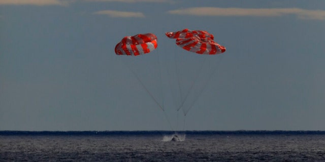 In this photo provided by NASA the Orion spacecraft for the Artemis I mission splashes down in the Pacific Ocean after a 25.5 day mission to the Moon, Sunday, Dec. 11, 2022.